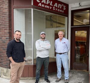 NCHC team members stand with the general contractor on the 1st day of construction at the Caplan's Building.