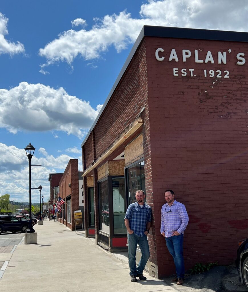 Craig Taylor and Chris Towne stand outside the Caplan's Building. 