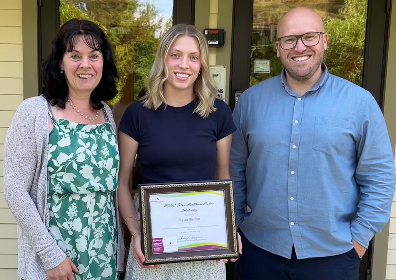 photo of 2025 scolarship winner with two directors on either side